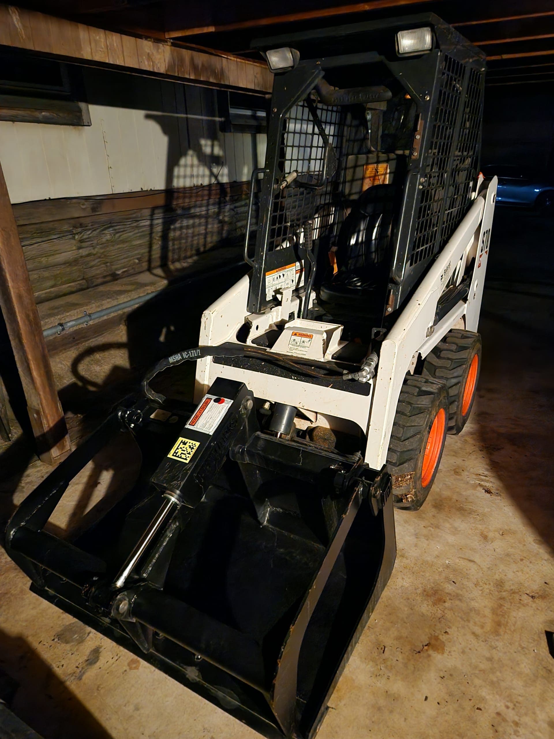 Compact Skid Steer Loader with Bucket and Grapple
